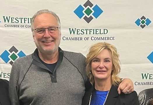 Dr. Tracey Ikerd and Sheri Ikerd posing in front of a Westfield Chamber of Commerce banner.